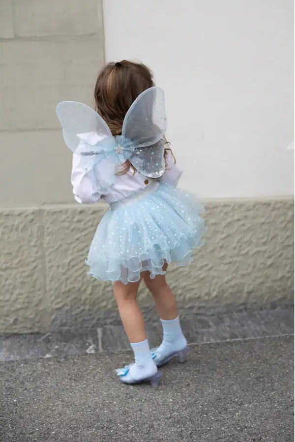Child in blue fairy costume with wings