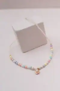 Colorful beaded necklace with seashell pendant.