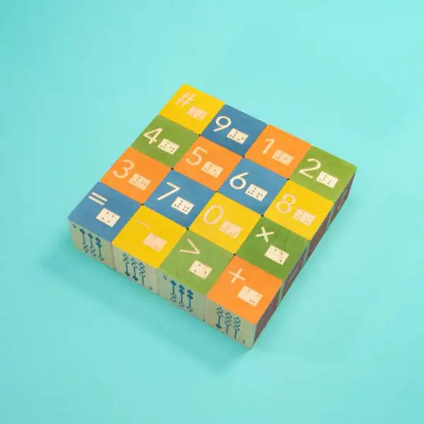 Colorful wooden math blocks on blue background.