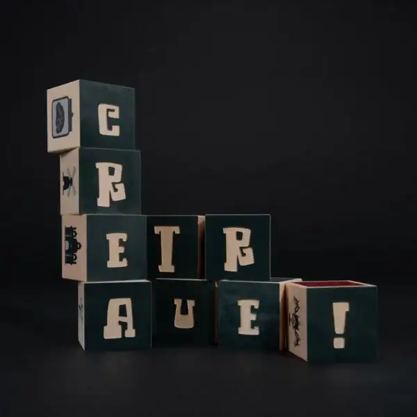 Blocks spelling 'Create' on black background.
