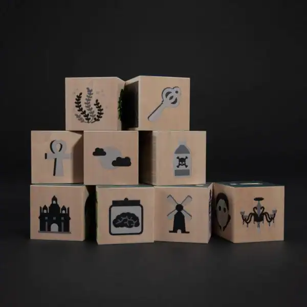 Wooden blocks with various black icons on display.