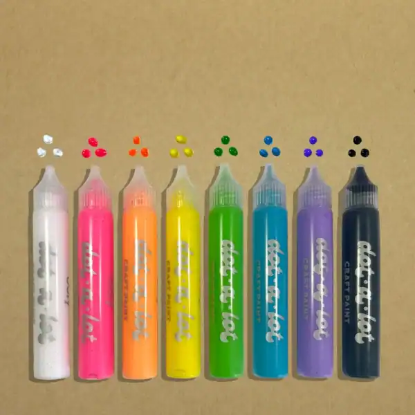 Eight colored craft paint bottles on cardboard background.