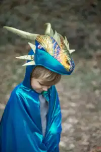 Child in blue dragon costume outdoors