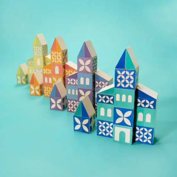 Colorful wooden block houses on blue background.