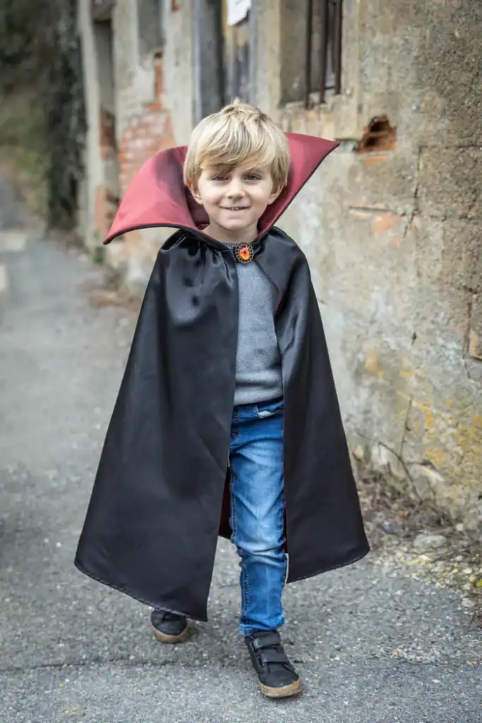 Child in vampire costume outdoors