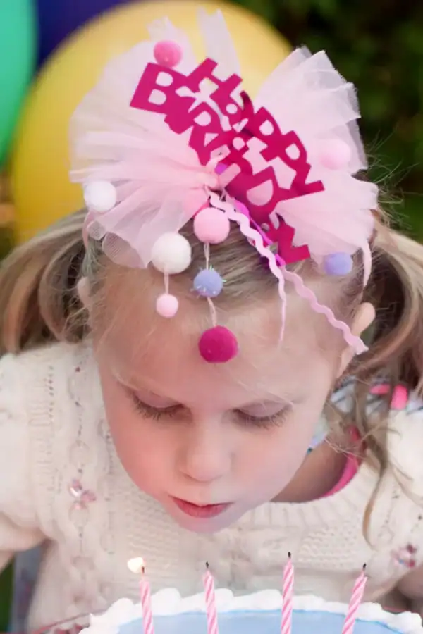 Child blowing out birthday candles