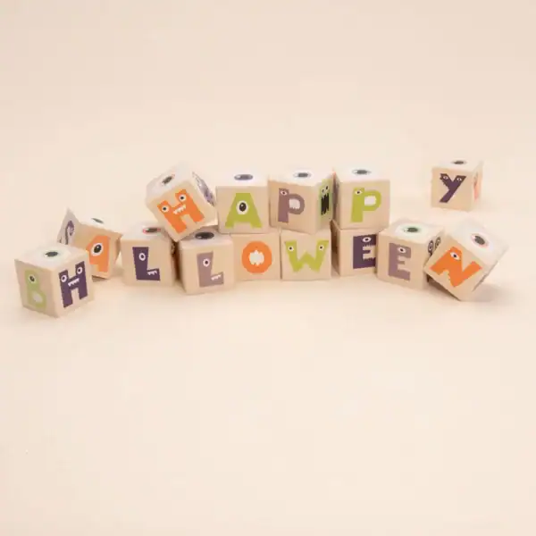 Halloween blocks with monster faces spelling 'Happy Halloween'.