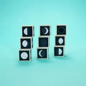 Stacked blocks showing moon phases on teal background.