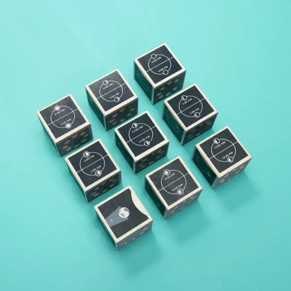 Nine moon phase dice on teal background.