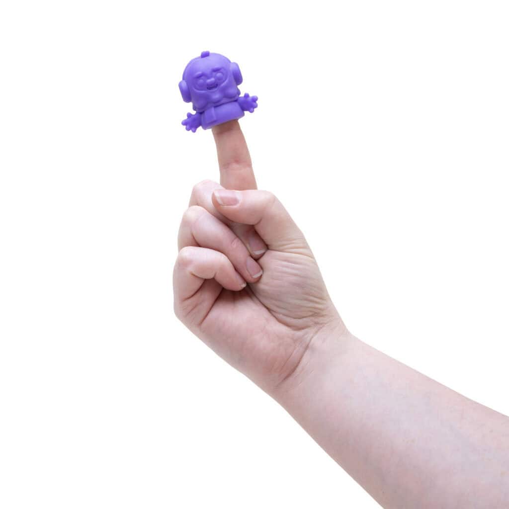 Hand with purple robot finger puppet.