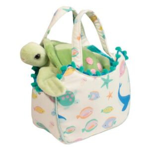 Plush turtle in colorful ocean-themed tote bag.