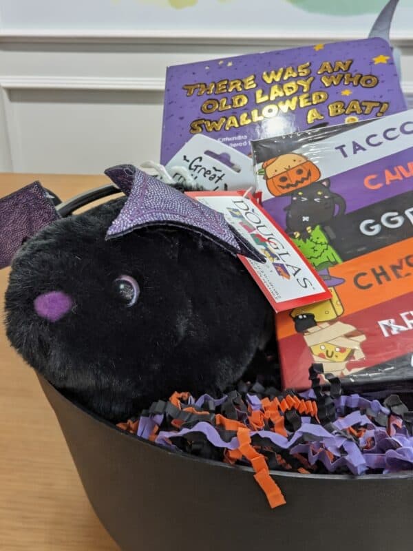 Halloween gift basket with toys and books.