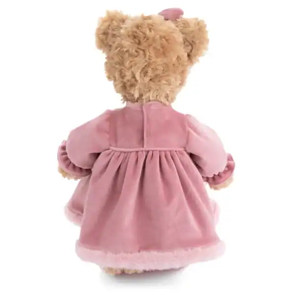 Fuzzy teddy bear in pink dress, back view.