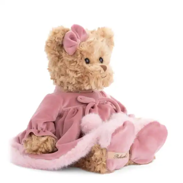 Plush teddy bear in pink dress with bow.