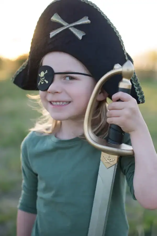 Child dressed as pirate with sword and eyepatch.