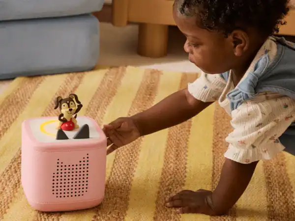 Baby interacting with a pink audio toy
