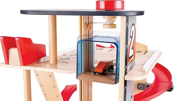 Wooden toy garage with red car on elevator.