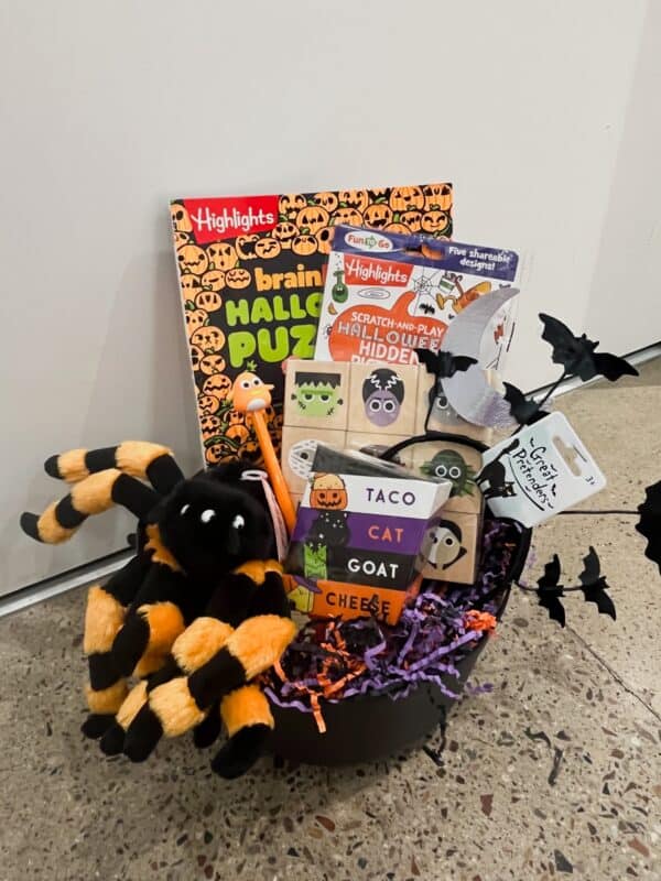 Halloween gift basket with toys and games.
