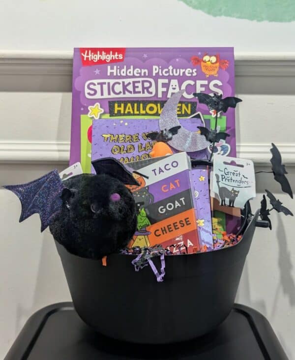 Halloween gift basket with toys and books.