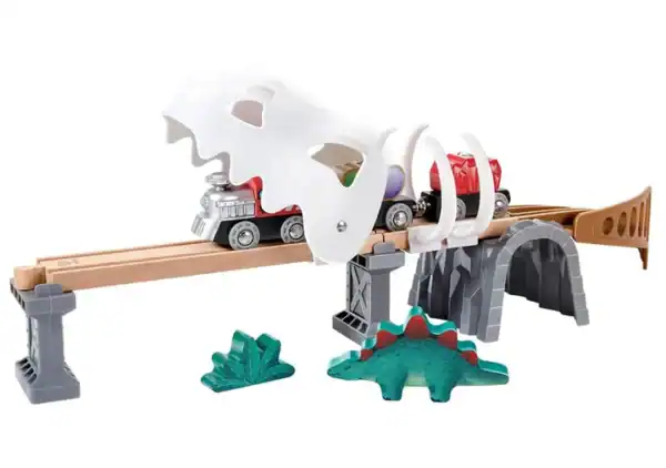 Toy train set with dinosaur-themed bridge.