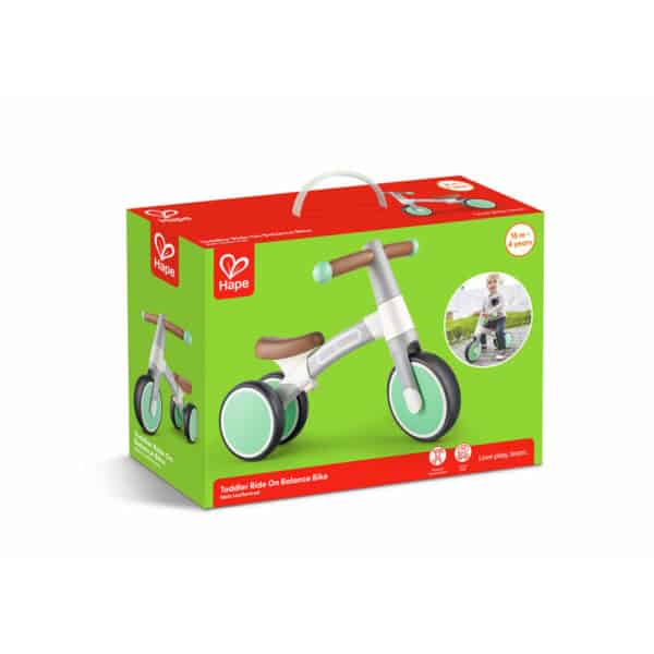 Toddler balance bike in box with child image.