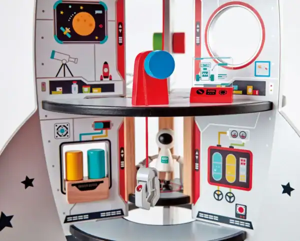 Toy rocket ship interior with space theme illustrations.