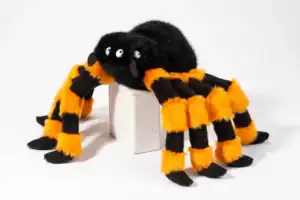 Furry black and orange spider toy on display