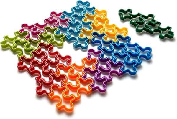 Multicolored interlocking puzzle pieces on white background.