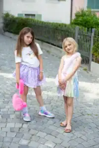 Two girls in colorful skirts and accessories