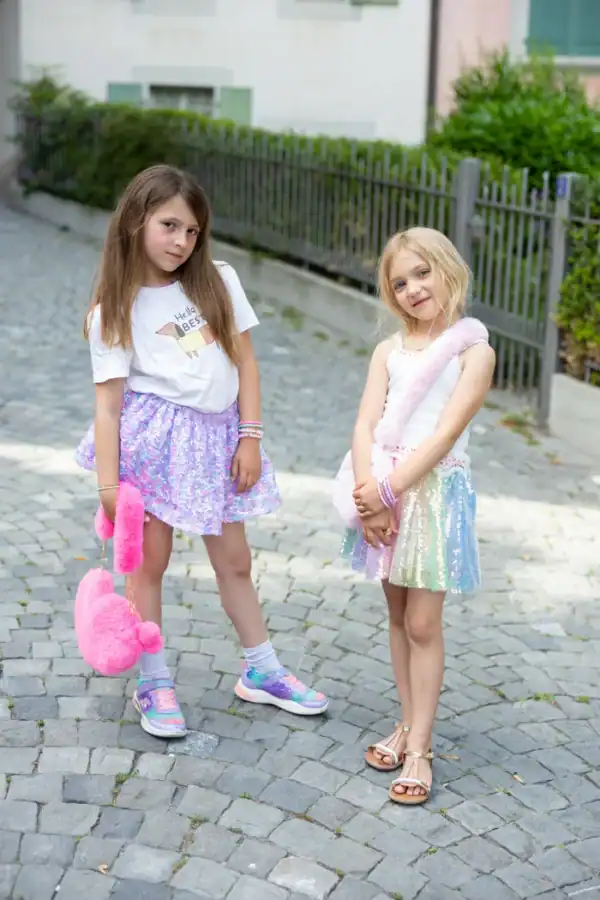 Two girls in colorful skirts and accessories