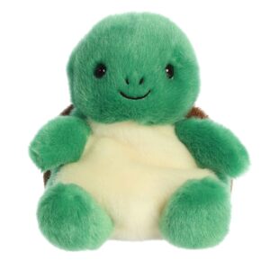Green plush turtle toy with a smiling face.