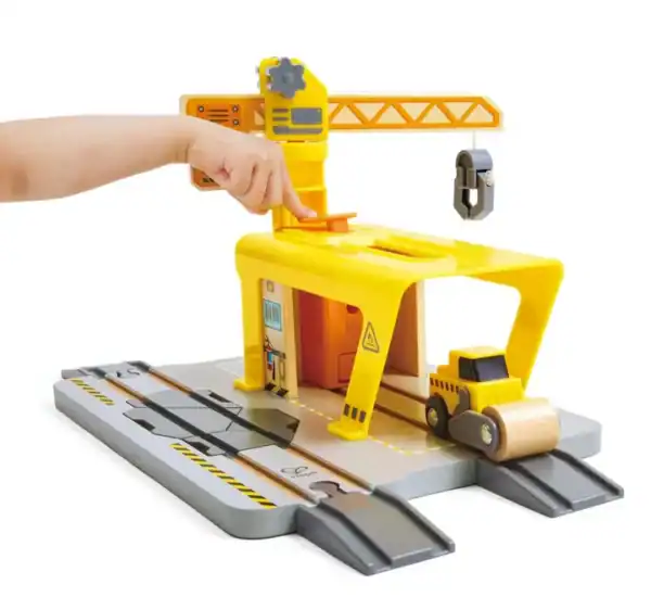 Child playing with construction toy set. Cranes and trucks.