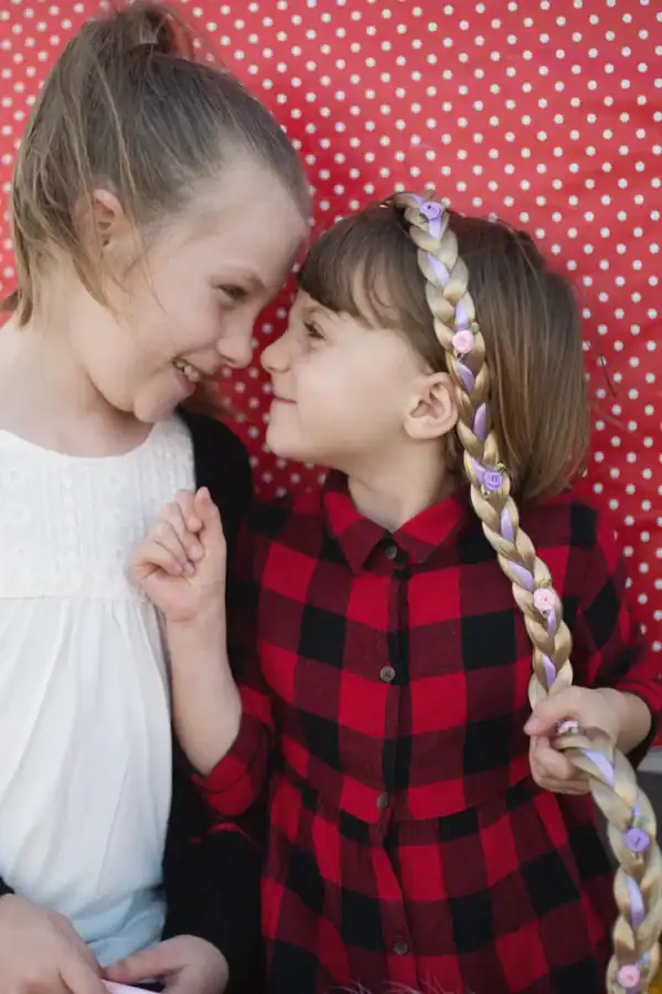 Two girls smiling with braided hair
