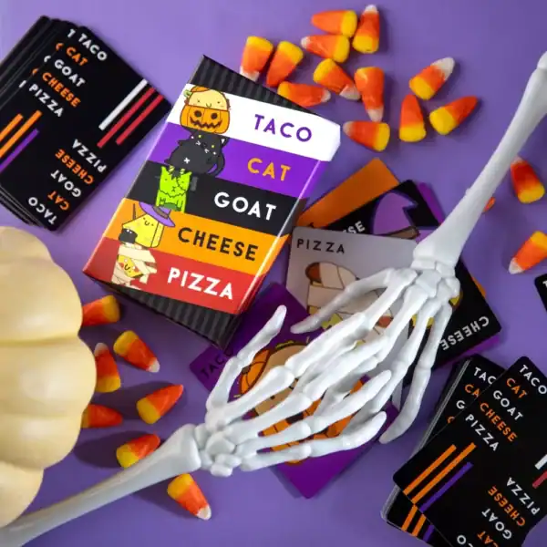 Halloween-themed card game with candy corn and skeleton arm.
