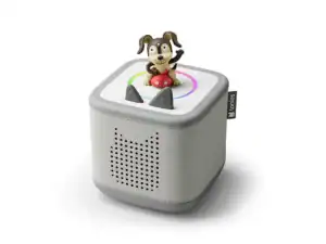 Toy speaker with dog figurine on top.