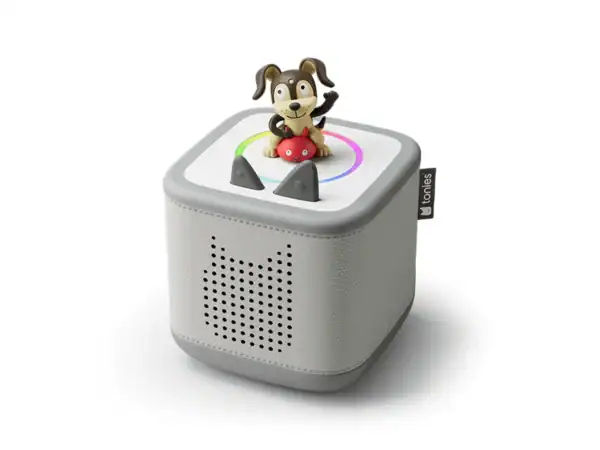 Toy speaker with dog figurine on top.