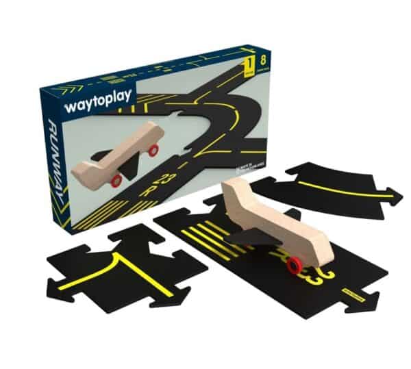 Toy runway set with wooden airplane and road pieces.