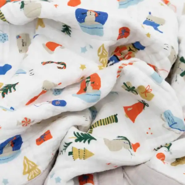 White muslin with colorful Christmas-themed prints.