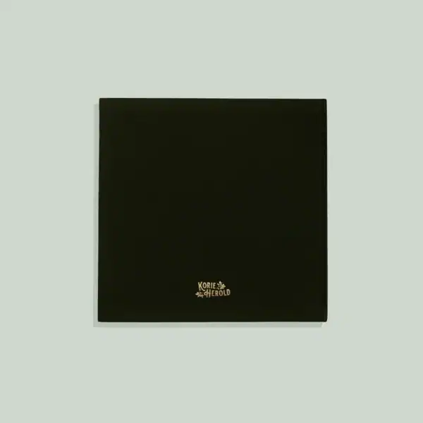 Dark green photo album on gray background.