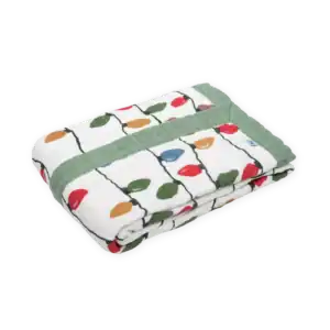 Colorful fruit-patterned quilt with green trim.