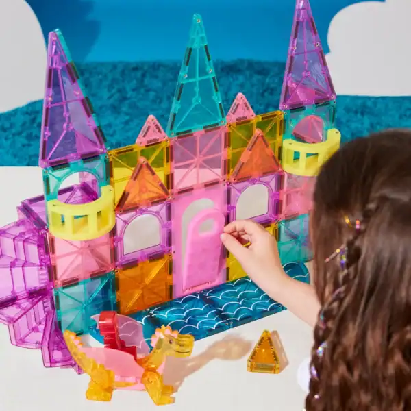 Child building colorful magnetic castle toy