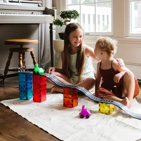 Children playing with colorful building blocks indoors.