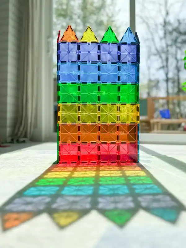Colorful magnetic tiles forming a castle with shadow.