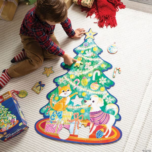 Child playing with Christmas tree floor puzzle.
