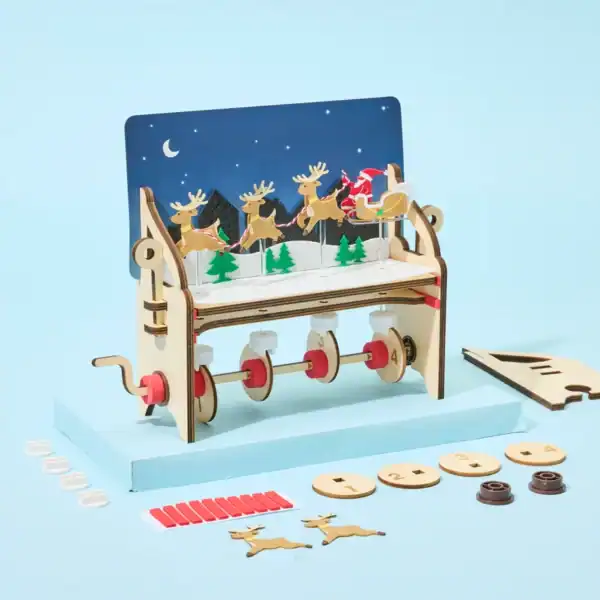 DIY mechanical toy with reindeer and sleigh scene.