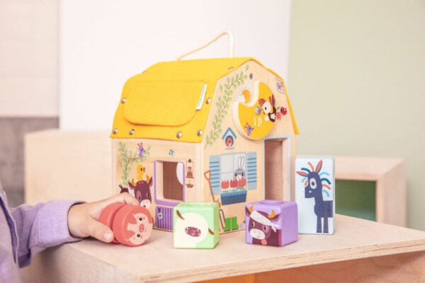 Child playing with colorful wooden animal blocks.