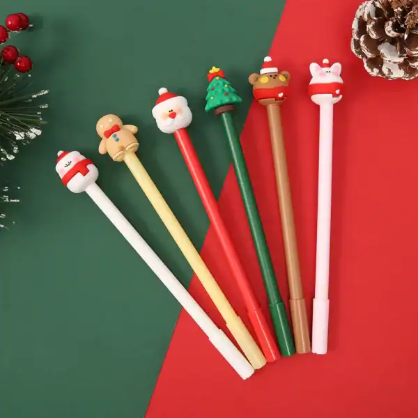 Colorful Christmas-themed pens on festive background.
