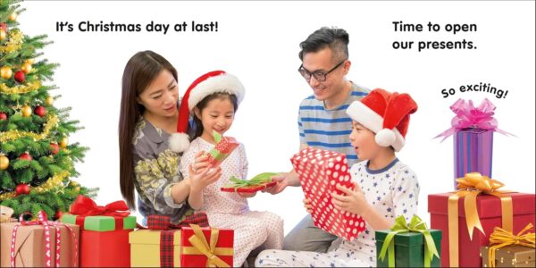 Family opening Christmas presents by tree.