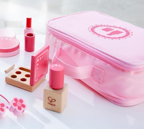 Pink toy makeup set with wooden pieces.