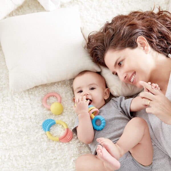 Mother and baby with colorful teething toys.